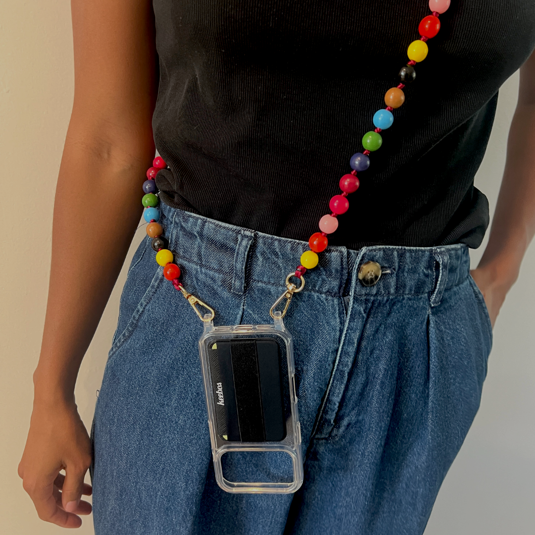 Person wearing a colorful beaded phone lanyard with a clear phone case.