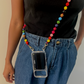Person wearing a colorful beaded phone lanyard with a clear phone case.