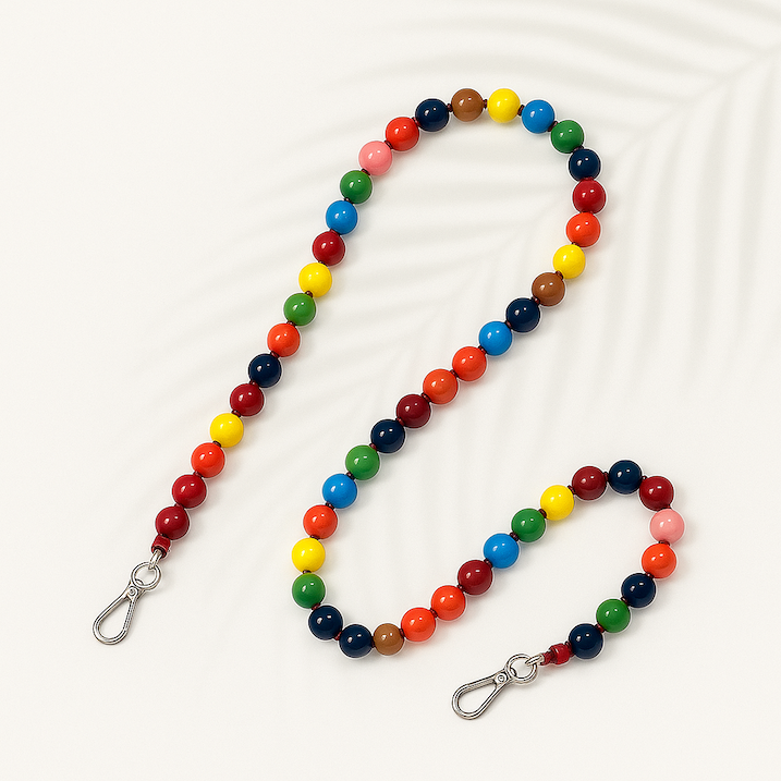 Colorful beaded lanyard with metal clips on a white background keebos