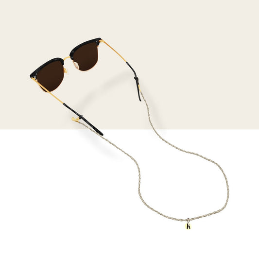 Cream sunglass strap: off-white woven vegan leather cord on sunglasses