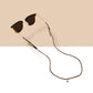 All three Keebos sunglass strap colors side by side: black, brown and pink, each on sunglasses with a gold Keebos pendant